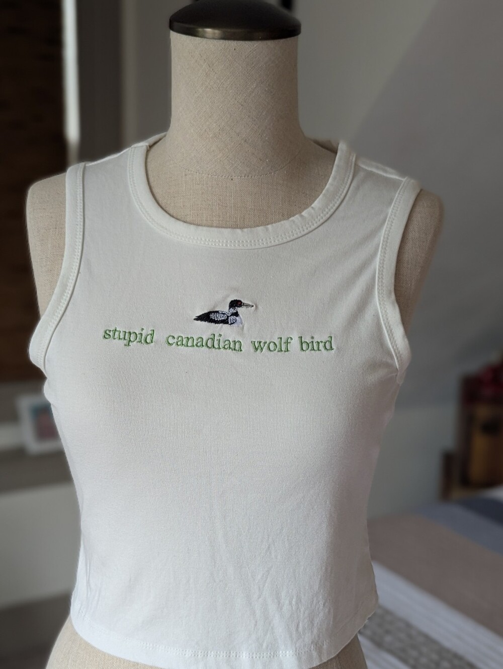 White Embroidered 'Stupid Canadian Wolf Bird' Crop Tank Top